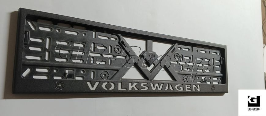 Рамка номерного знаку з написом і логотипом "VOLKSWAGEN" чорна порошкова фарба, напис: білого кольору 16054/L фото