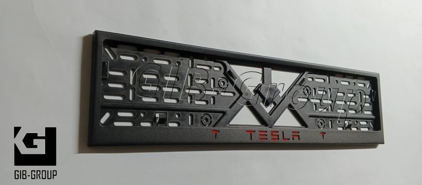 Рамка номерного знака с надписью и логотипом "TESLA" черная порошковая краска, надпись: красного цвета 16061 фото